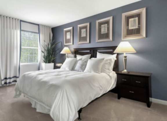 a bedroom with a bed and a carpet with colored dots