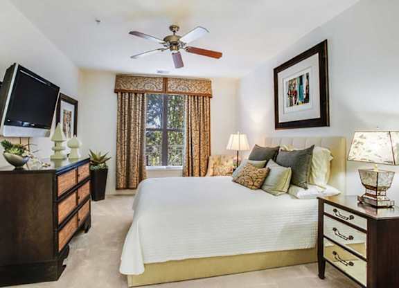 a bedroom with a large bed and a tv