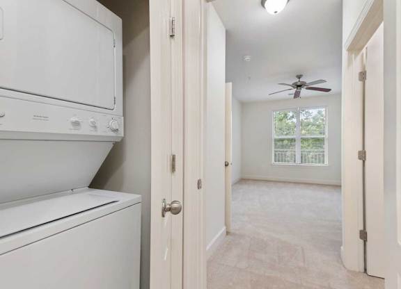 an empty laundry room with a washer and dryer