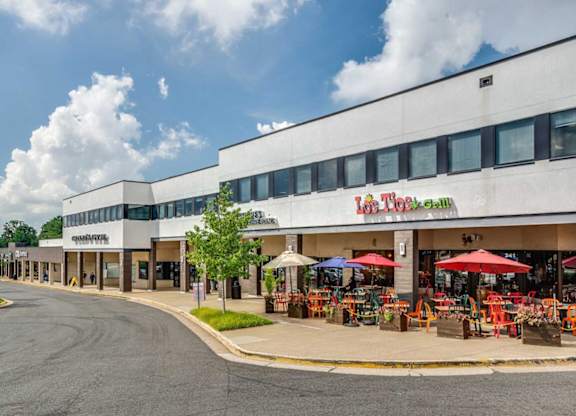 A street view of a shopping area with a store named
