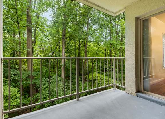 a balcony with a view of the woods