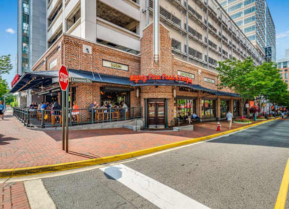 a street view of a restaurant on the corner of a city street