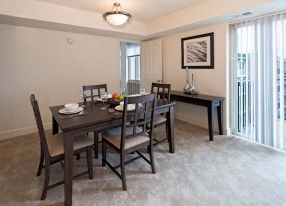A dining room with a table set for two.