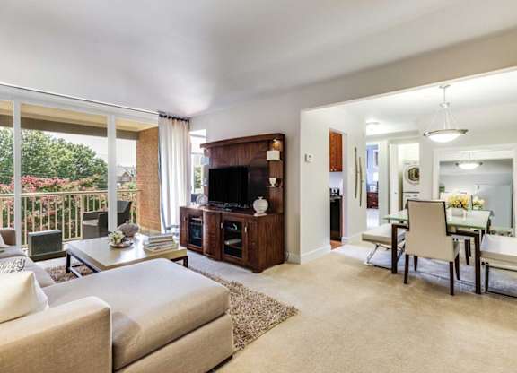 A living room with a white couch and a television.