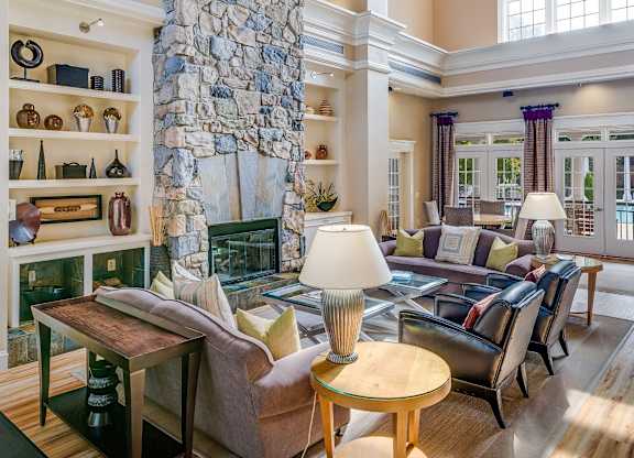 A living room with a stone pillar and a fireplace.