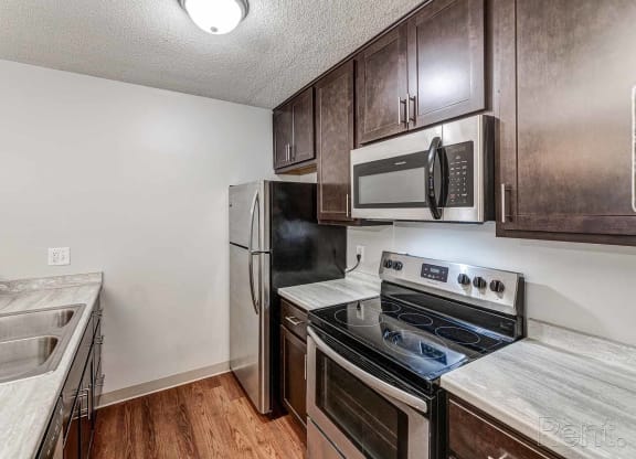 a kitchen with stainless steel appliances and wooden cabinets