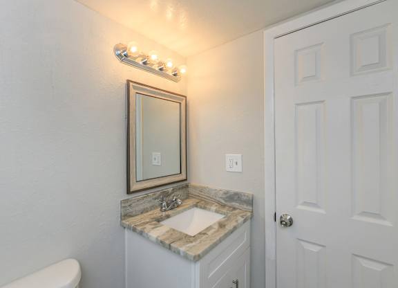 a small bathroom with a sink and a mirror