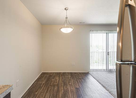 Spacious dining room with natural light at Knottingham Apartments in Clinton Township, MI