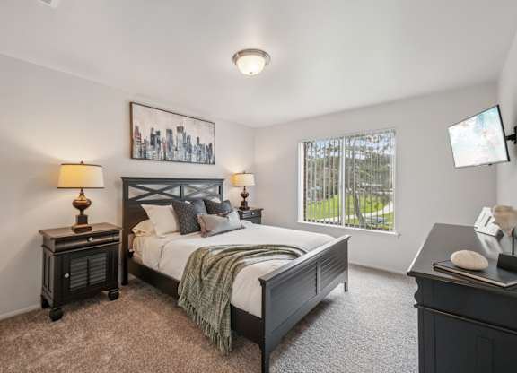 Cozy bedroom with ample storage space at Drawbridge Apartments in Harrison Township, MI.