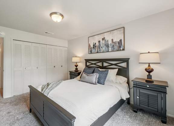 Cozy bedroom with ample storage space at Drawbridge Apartments in Harrison Township, MI.