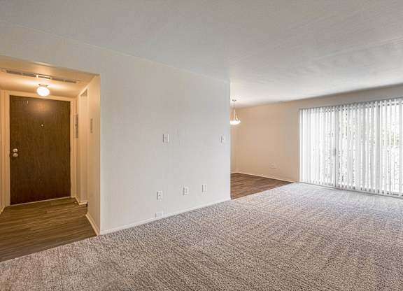 Open and airy entry way and living room at Knottingham Apartments in Clinton Township, MI