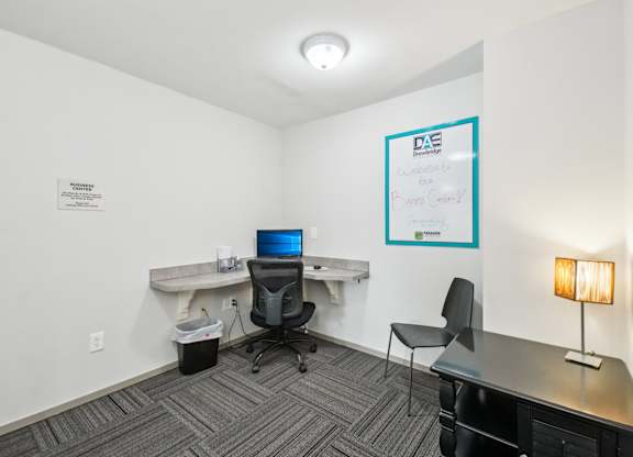 Modern business center with computer at Drawbridge Apartments in Harrison Township, MI.