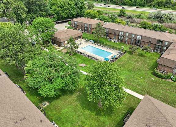 Expansive green space and heated pool at Drawbridge Apartments in Harrison Township, MI.