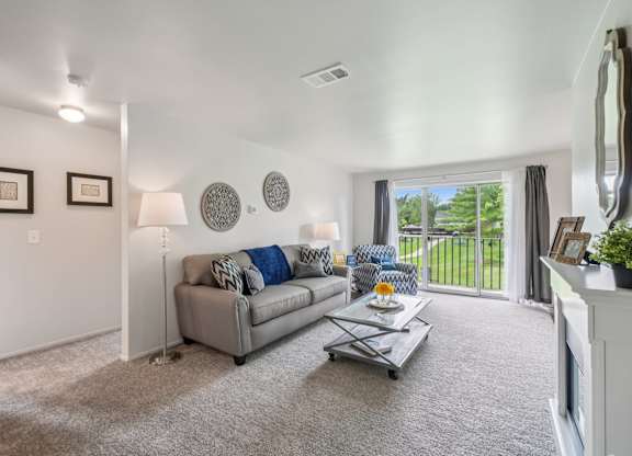 Elevated living room and private patio or balcony at Drawbridge Apartments in Harrison Township, MI.