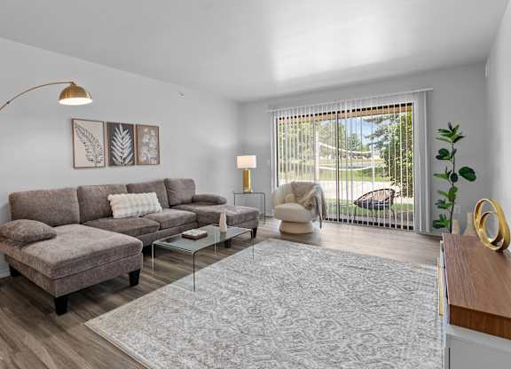 Living room with patio at Dover Hills Apartments in Kalamazoo