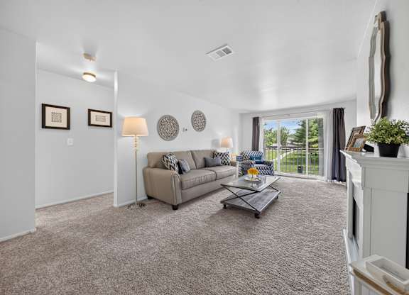 Elevated living room and private balcony at Drawbridge Apartments in Harrison Township, MI.