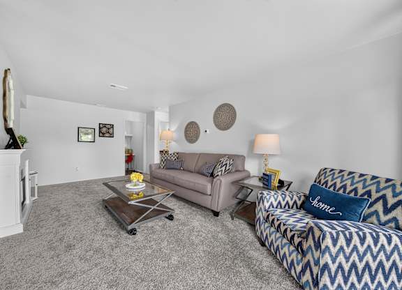 Elevated living room with a private balcony at Drawbridge Apartments in Harrison Township, MI.