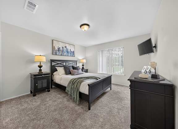 Cozy bedroom with ample storage space at Drawbridge Apartments in Harrison Township, MI.