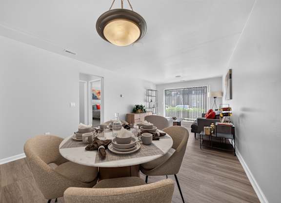 Open concept Living-Dining Area with natural lighting at Lakeside Village Apartments Clinton Township, MI