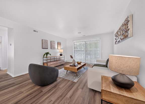 Spacious Living Room with Sliding Glass Door at Lakeside Village Apartments Clinton Township MI