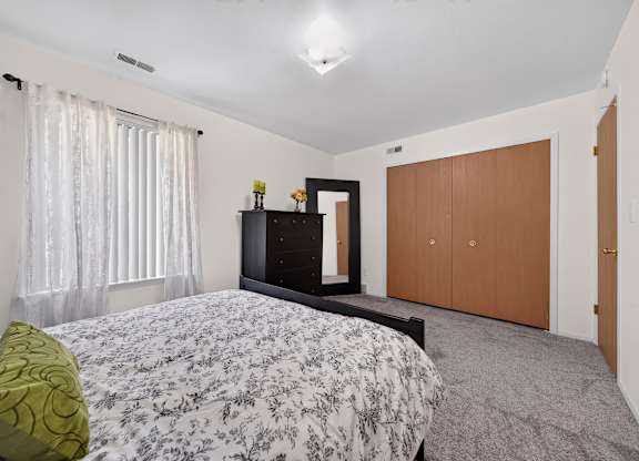 Spacious bedroom with ample storage at Eastwood Village Apartments in Clinton Township, MI.
