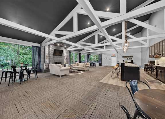 A spacious room with a patterned floor and a bar area.
