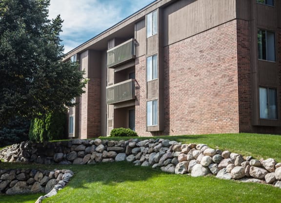 Exterior building with trees in courtyard at Dover Hills Apartments in Kalamazoo, MI
