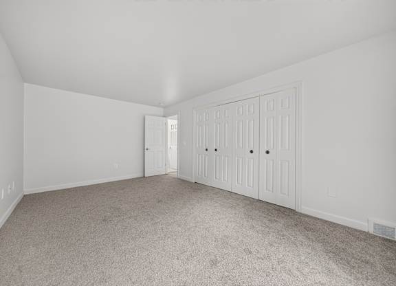 Cozy bedroom with ample storage space at Franklin River Apartments in Southfield, MI.