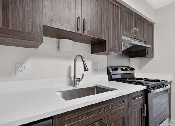 Modern kitchen with stainless steel appliances at Franklin River Apartments in Southfield, MI.