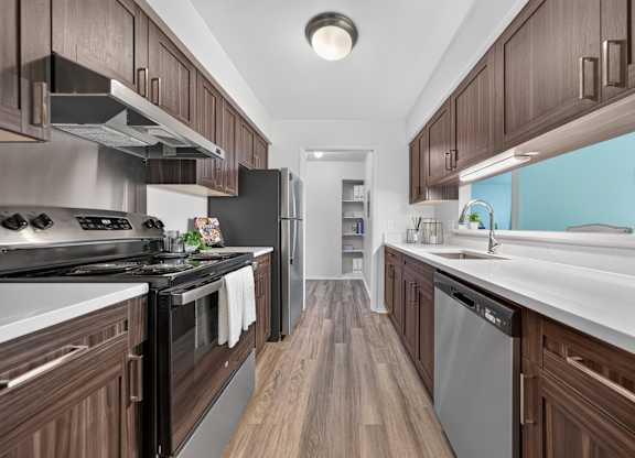 Modern kitchen with stainless steel appliances at Franklin River Apartments in Southfield, MI.