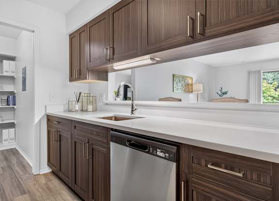 Modern kitchen with stainless steel appliances and pantry at Franklin River Apartments in Southfield, MI.