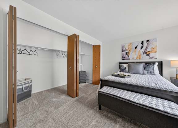 Bedroom with ample storage space at Franklin River Apartments in Southfield, MI.