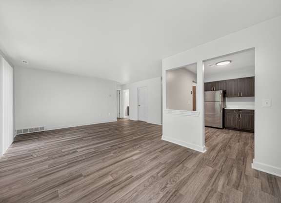 Open and airy living and dining room at Franklin River Apartments in Southfield, MI.