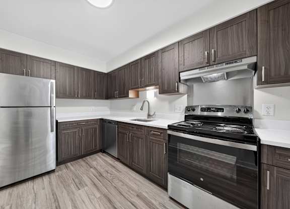 Modern kitchen with stainless steel appliances at Franklin River Apartments in Southfield, MI.