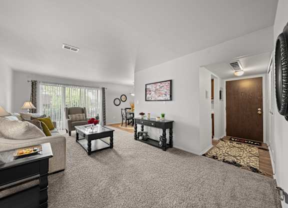 Open and airy living room with natural lighting at Knottingham Apartments in Clinton Township, MI.