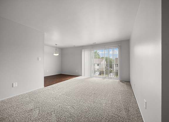 Open and airy living room with natural lighting at Knottingham Apartments in Clinton Township, MI.