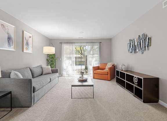Spacious Living Room with Sliding Glass Door at Lakeside Village Apartments Clinton Township MI