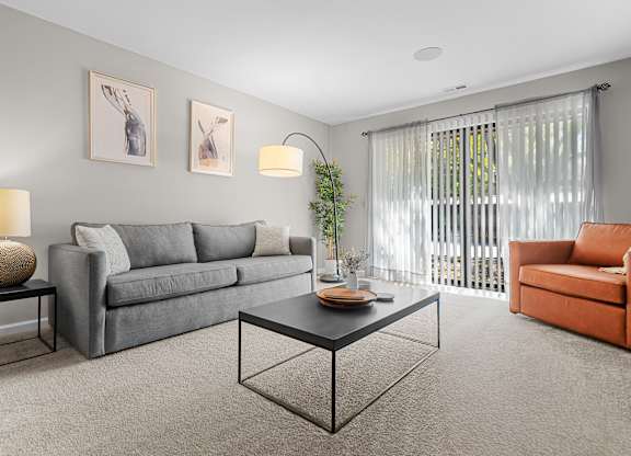 Spacious Living Room with Sliding Glass Door at Lakeside Village Apartments Clinton Township MI