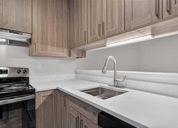 Modern kitchen with under cabinet lighting at Park Lane Apartments in Southfield, MI.