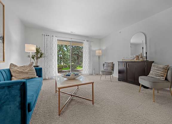 Spacious Living room with patio at Prentiss Pointe Apartments in Harrison Township