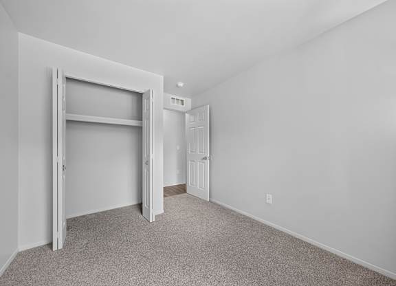 Cozy bedroom with ample storage at Woodland Villa Apartments in Westland, MI.