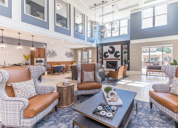 a resident clubhouse with couches chairs and a coffee table