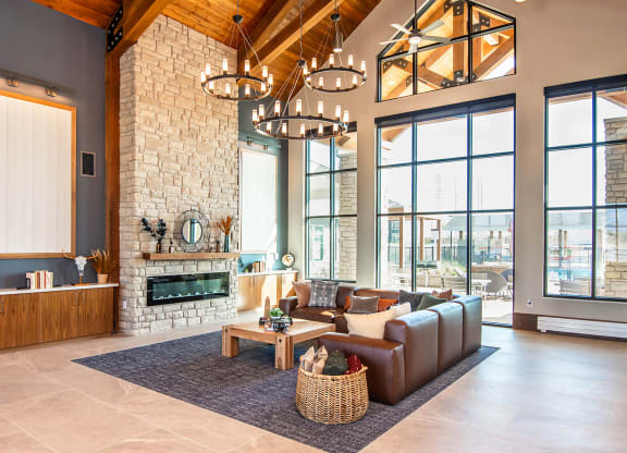 a living room with a fireplace and large windows