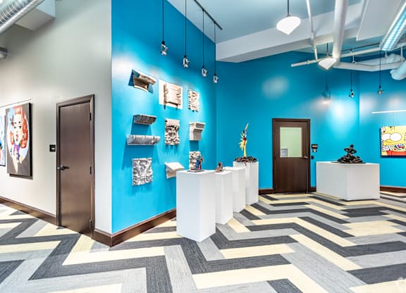 A room with blue walls and a white reception desk.