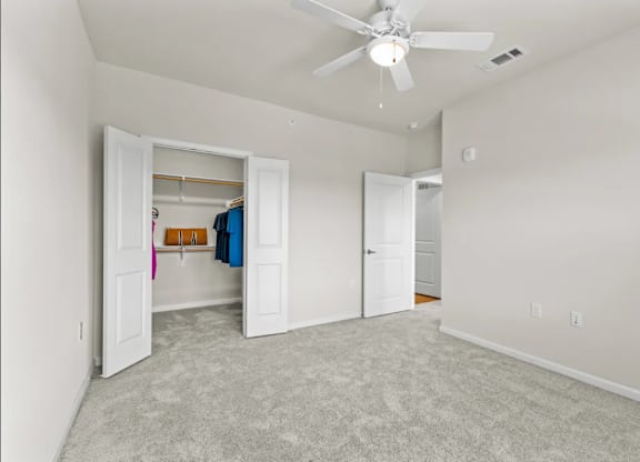 a bedroom with a closet and a ceiling fan at Cypress Creek at River Oaks, Waxahachie, 75165