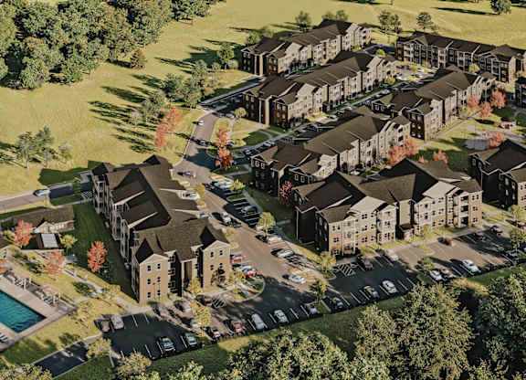 A bird's eye view of a housing complex surrounded by trees at Sage at Franklin Park Apartment , Austin, TX
