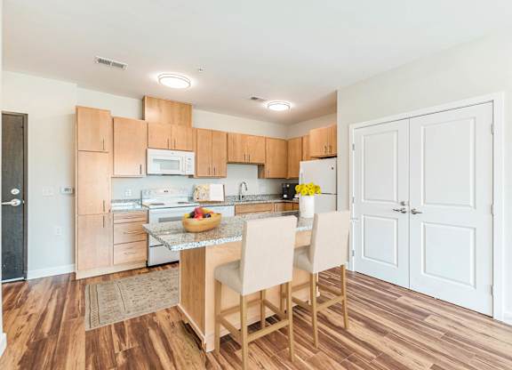 A kitchen with wooden floors and white walls. at Avery Landing Apartments, Greenville, SC
