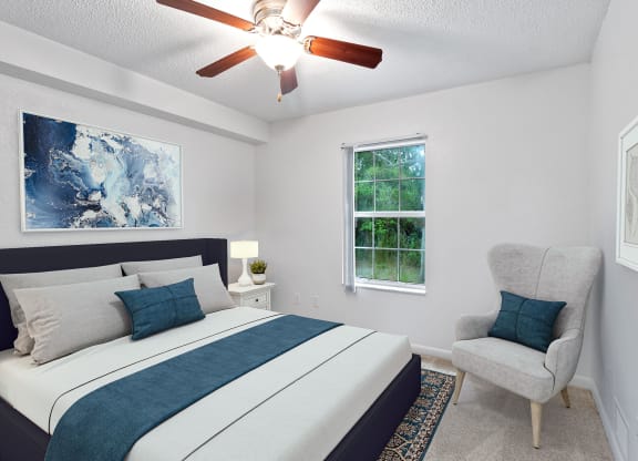 a bedroom with a bed and a ceiling fan
