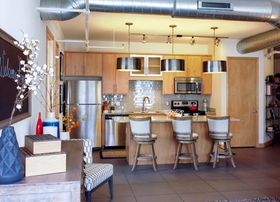 Kitchen with living room view at Arcade Apartments, St Louis, MO