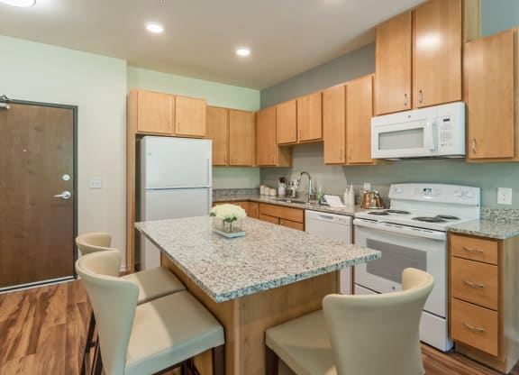 Kitchen with island at Covington Crossings 55+ Senior Living, Covington